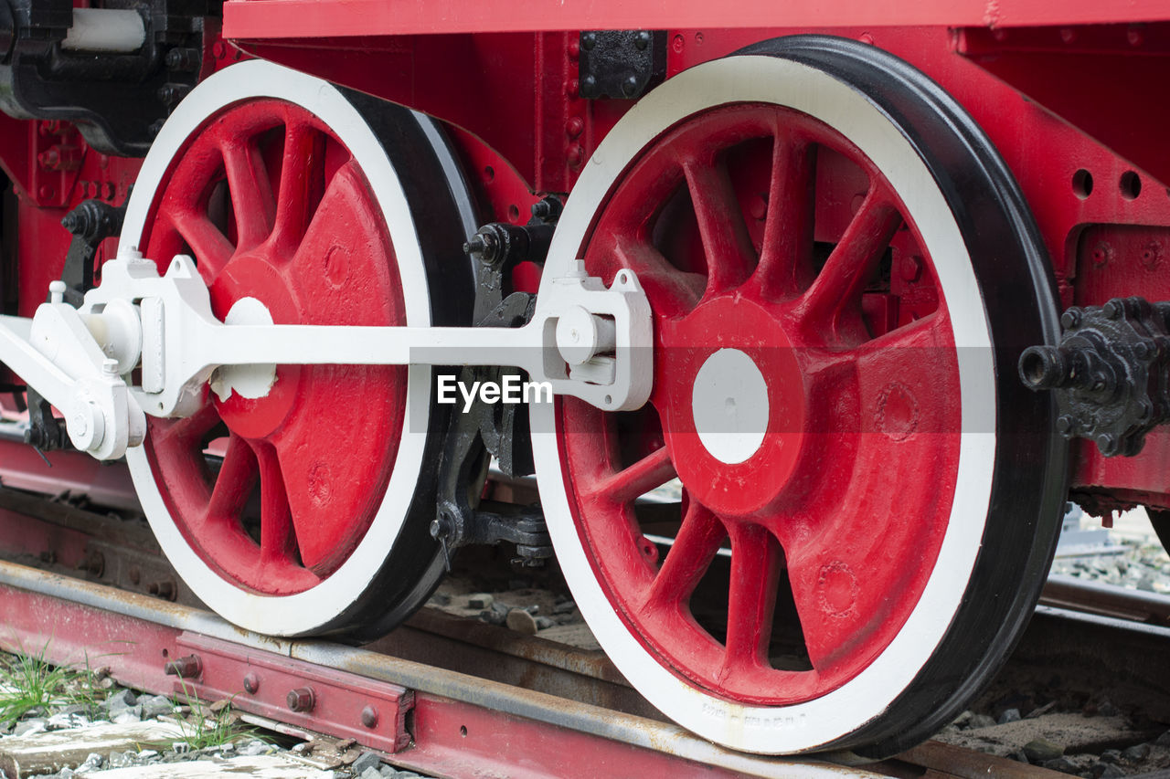 CLOSE-UP OF RED TRAIN ON RAILROAD TRACK