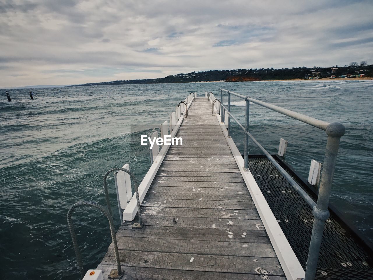 Pier over sea against sky