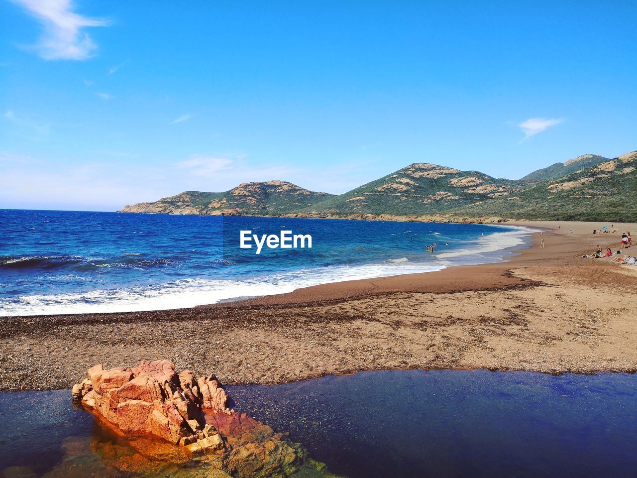 Scenic view of beach against blue sky