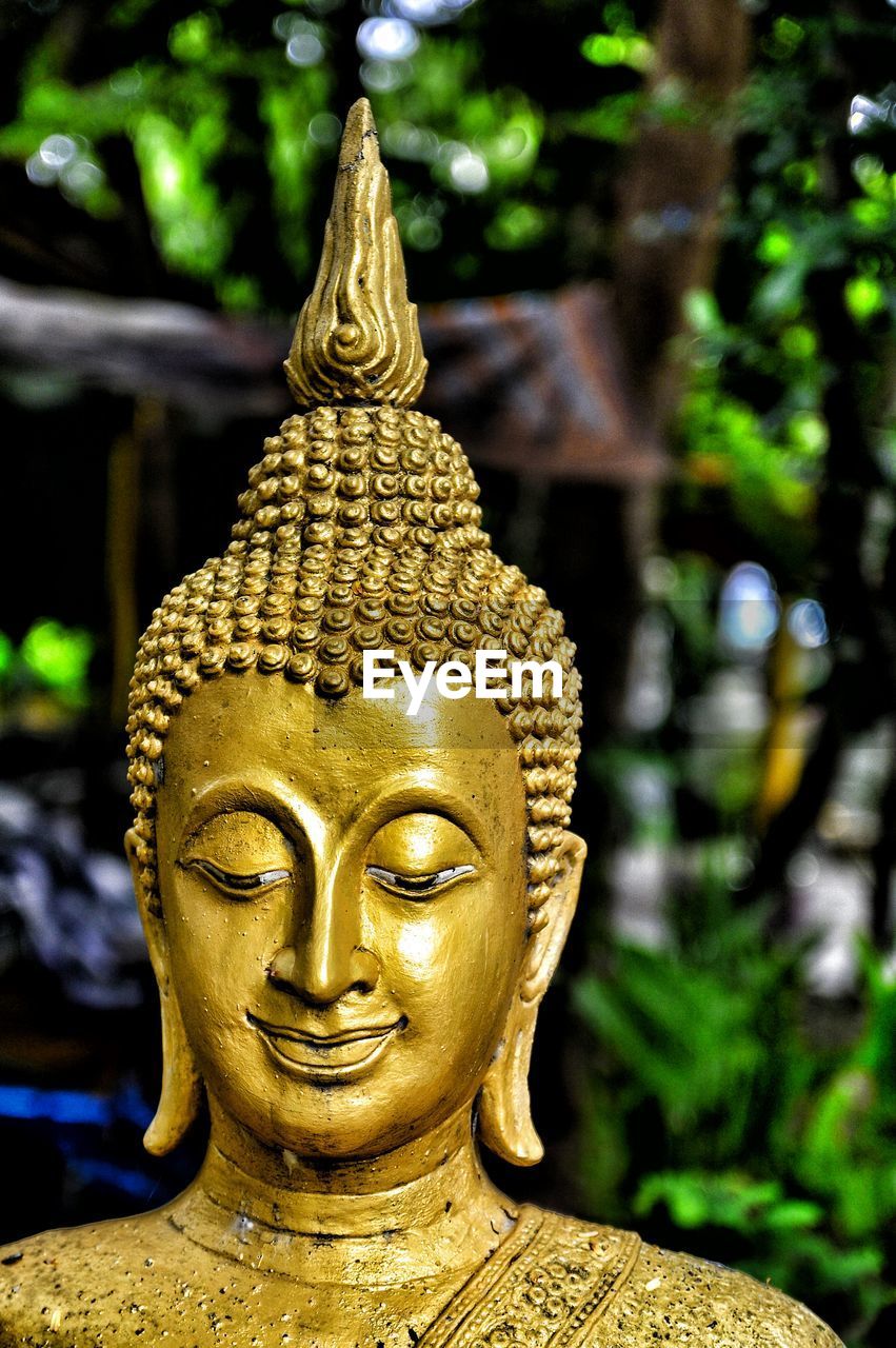 Close-up of gold statue of buddha