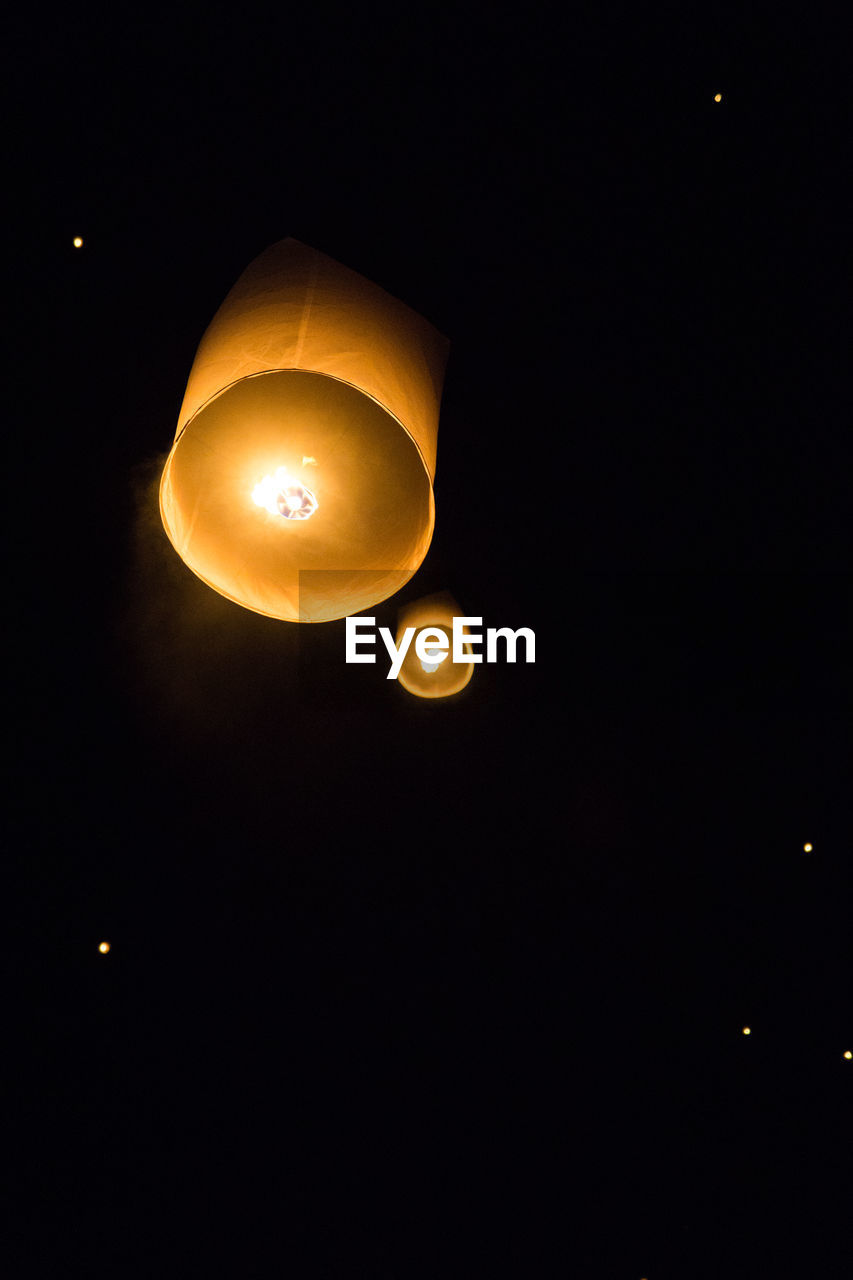 LOW ANGLE VIEW OF ILLUMINATED LANTERN AGAINST SKY