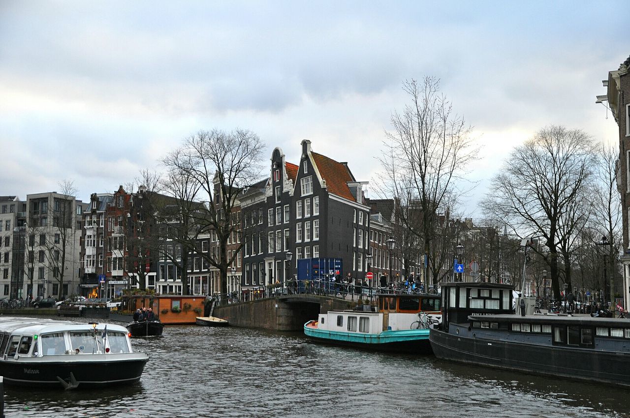 Buildings in city against cloudy sky