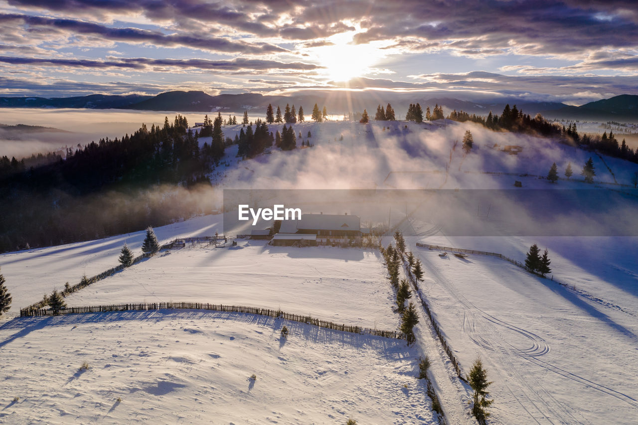 View of snow covered land against sky