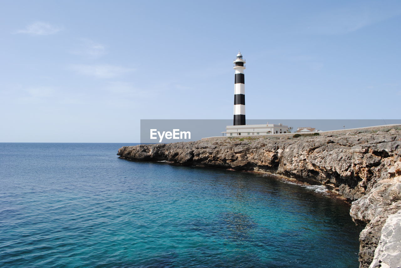 Low angle view of lighthouse at by sea at minorca
