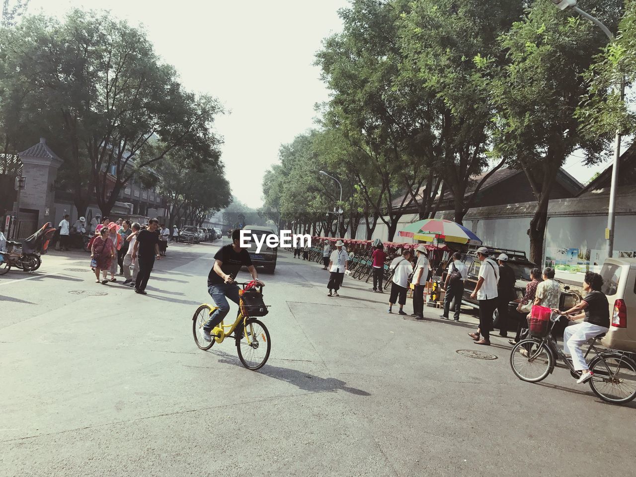 PEOPLE RIDING BICYCLES ON CITY STREET