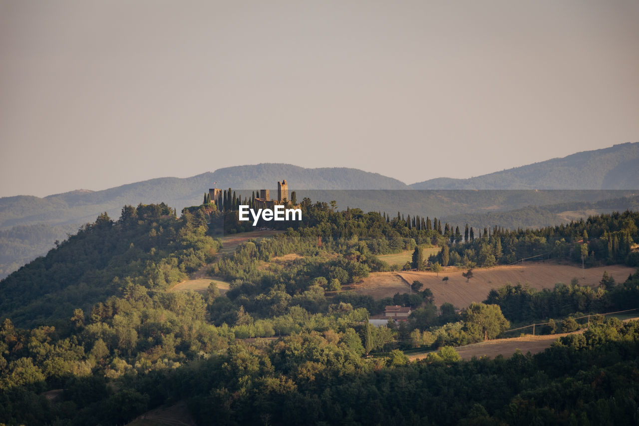 Ruins of an ancient medieval castle at sunset in the tuscan hills