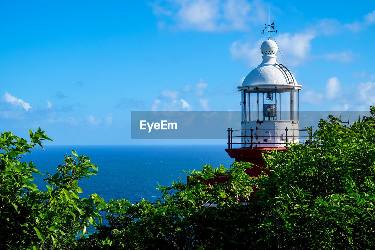 Scenic view of sea by building against sky