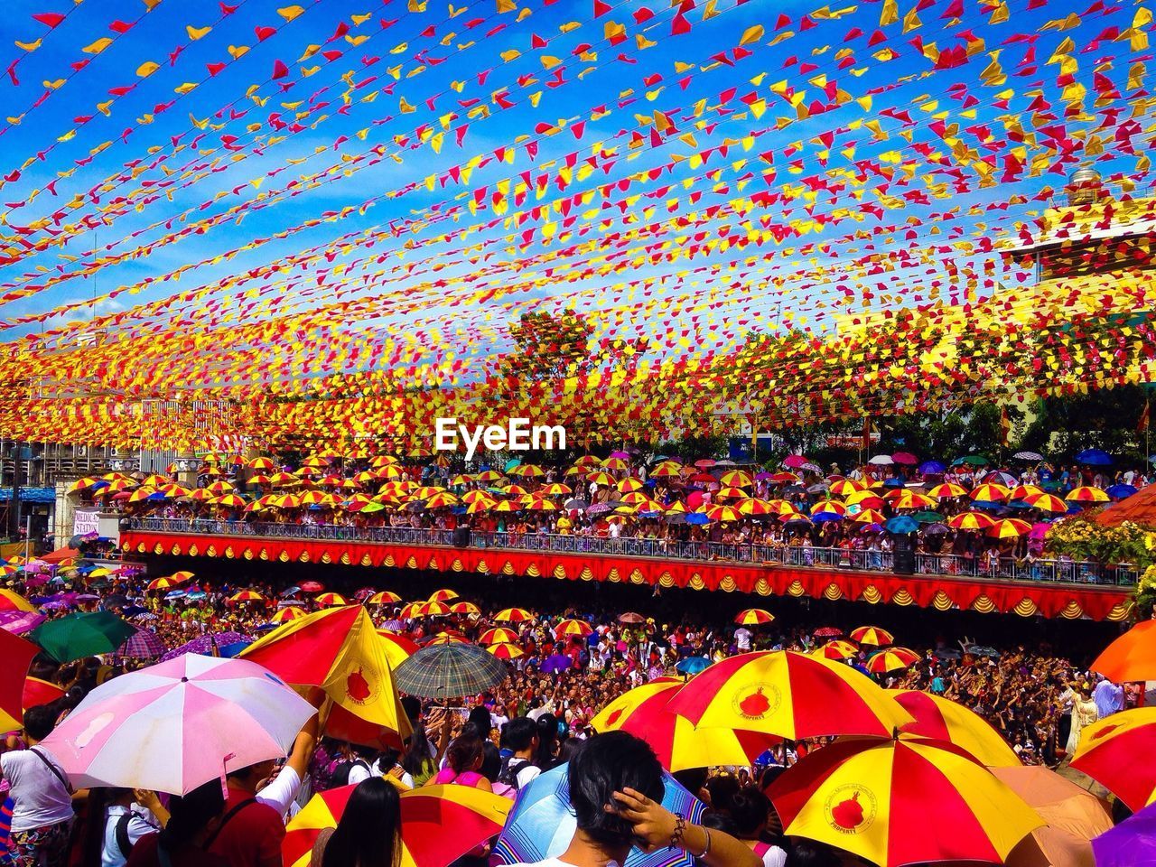 GROUP OF PEOPLE ON MULTI COLORED UMBRELLA