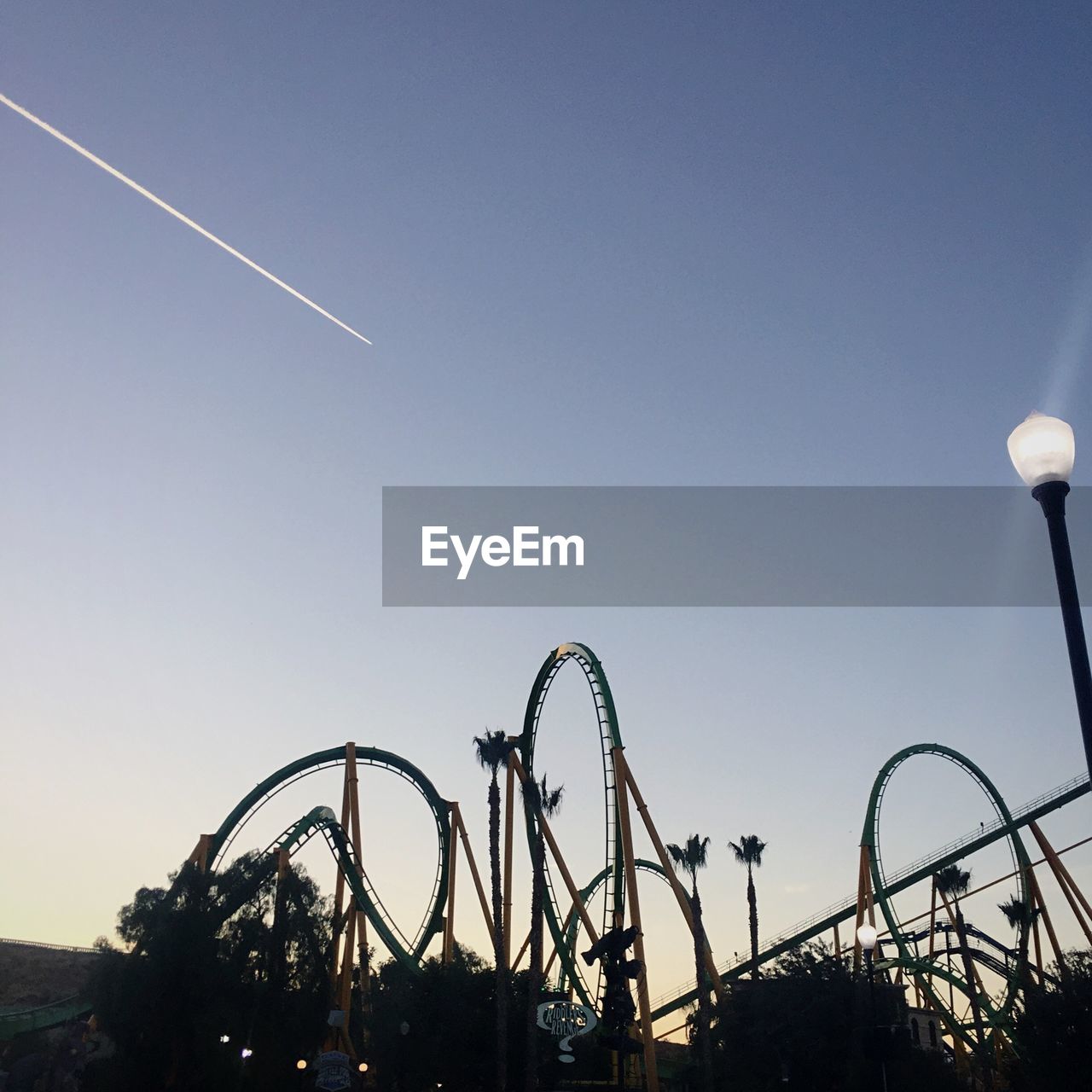 LOW ANGLE VIEW OF AMUSEMENT PARK AGAINST SKY