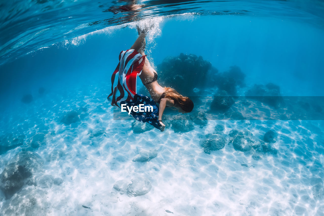 high angle view of woman swimming in sea