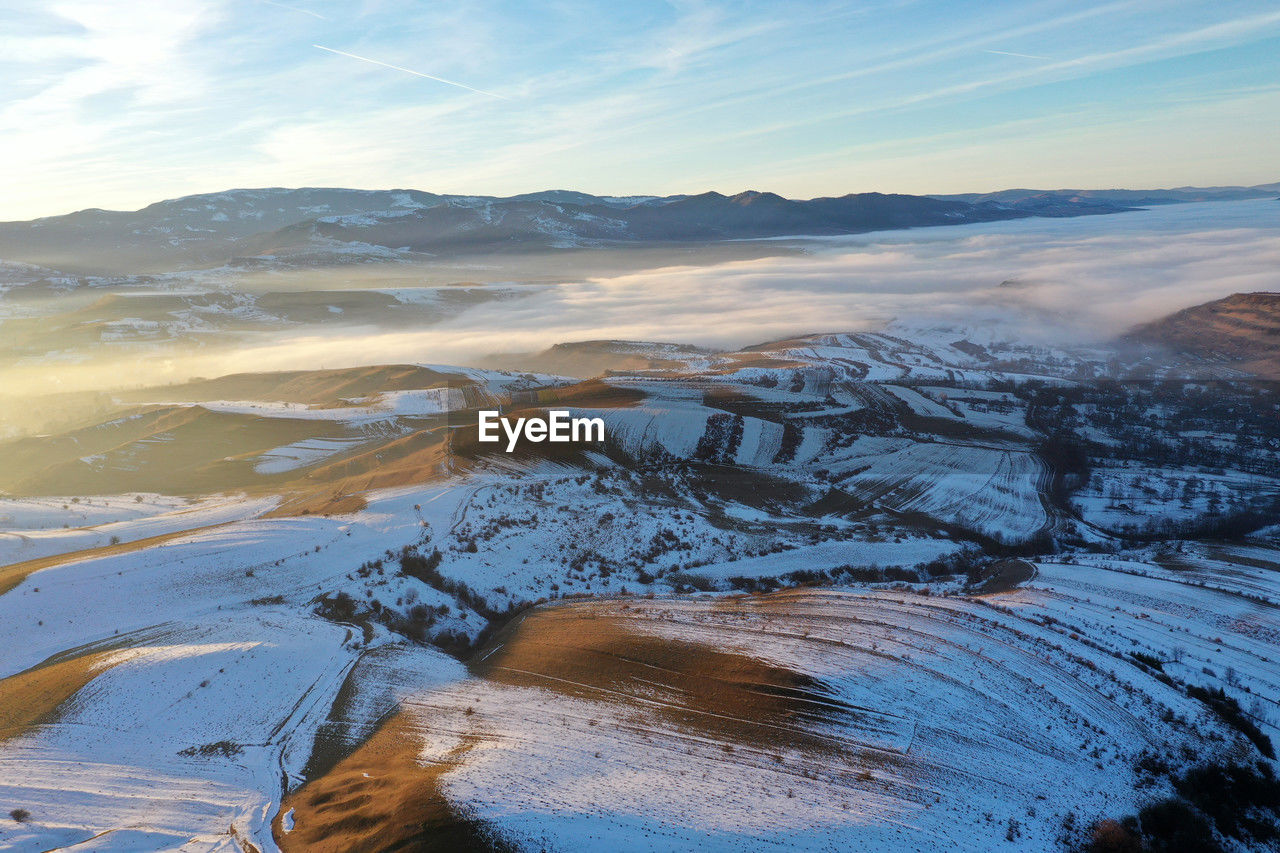 environment, landscape, scenics - nature, winter, beauty in nature, snow, sky, nature, cold temperature, mountain, water, land, tranquility, wilderness, no people, cloud, travel, mountain range, travel destinations, tranquil scene, non-urban scene, wave, ice, reflection, morning, outdoors, plateau, sea, blue, frozen, day, natural environment, sunrise, tourism, sunlight, coast, idyllic