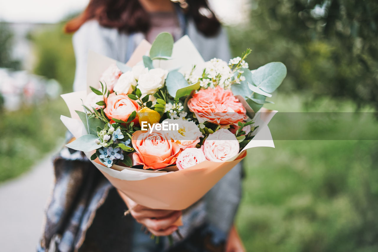 Young woman with bouquet of flowers 