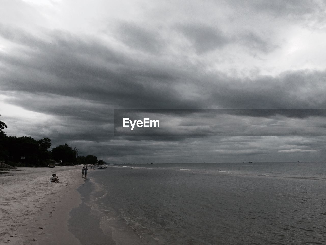 VIEW OF BEACH AGAINST CLOUDY SKY