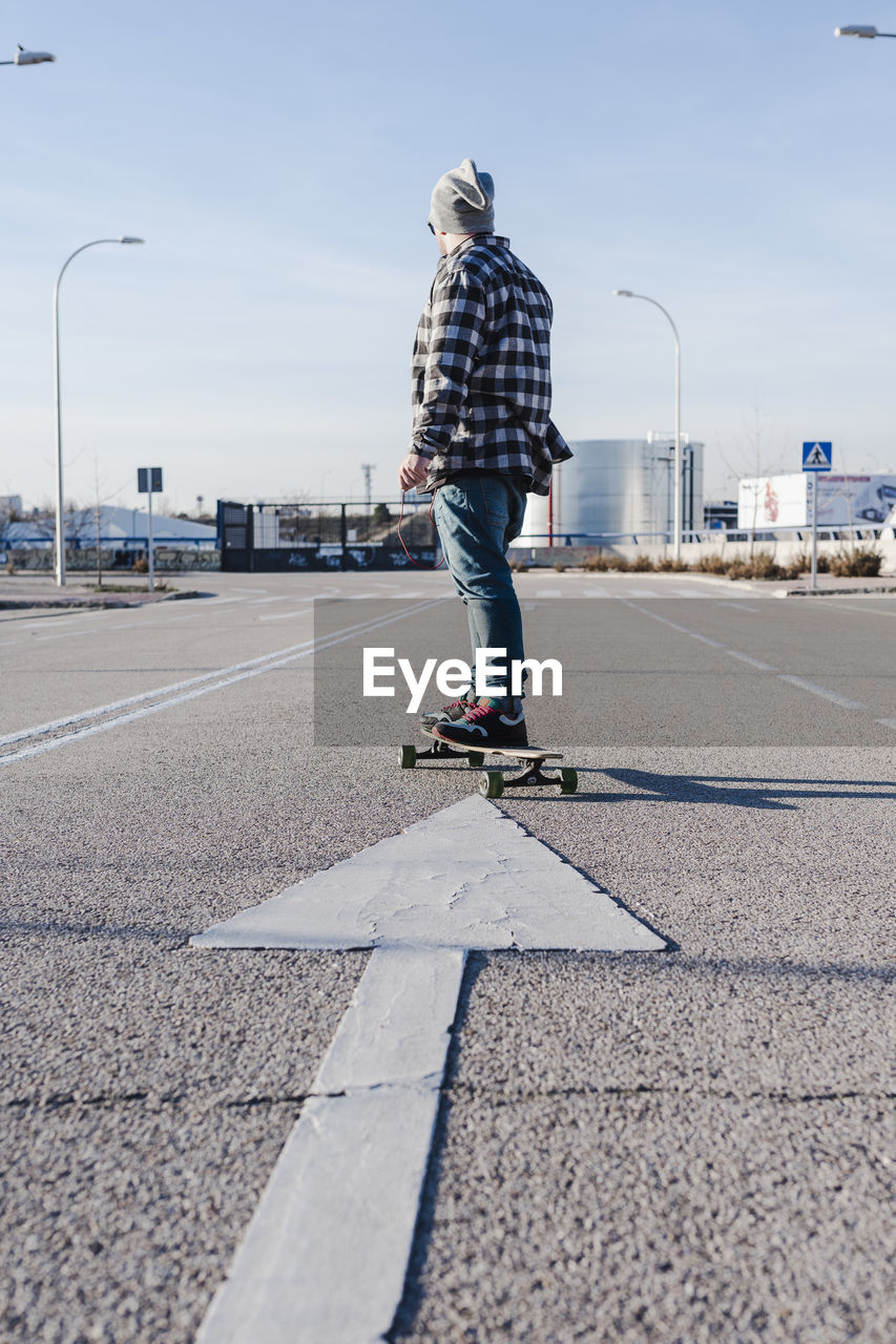 Close-up of anonymous man on longboard