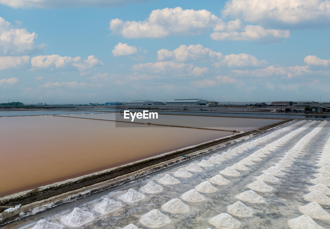 Aerial view of sea salt farm. pile of brine salt. raw material of salt industrial. sodium chloride