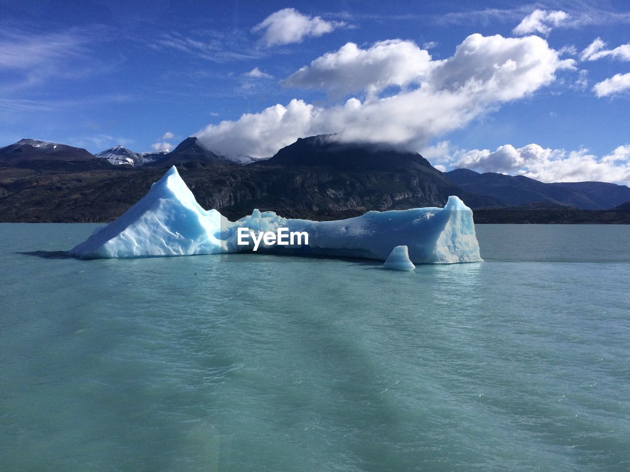 SCENIC VIEW OF SEA AGAINST MOUNTAIN RANGE