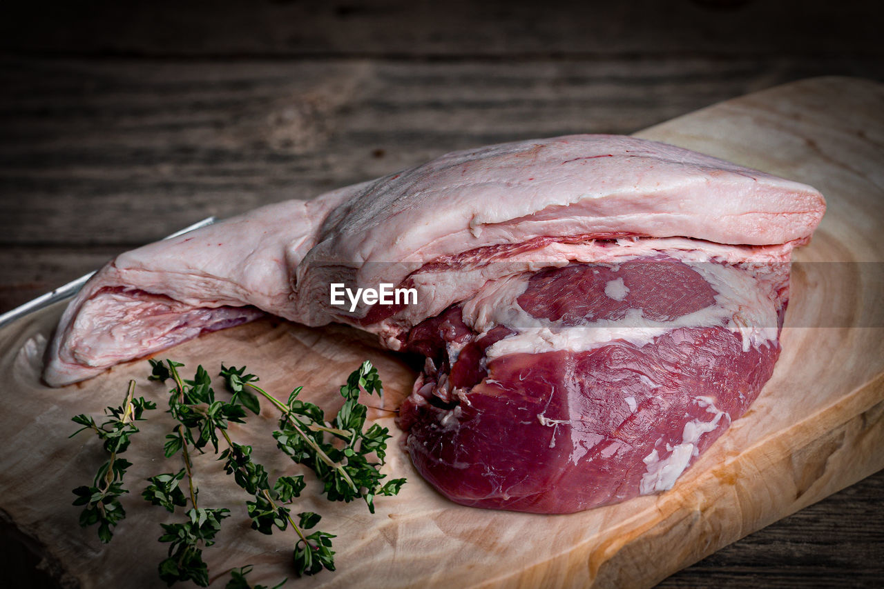 food and drink, food, meat, freshness, animal fat, raw food, red meat, cutting board, lamb and mutton, indoors, wood, dish, no people, beef, table, still life, herb, healthy eating, goat meat, close-up, ingredient, studio shot, slice, steak, kobe beef, pork, capicola, spice, flesh, kitchen knife, plant