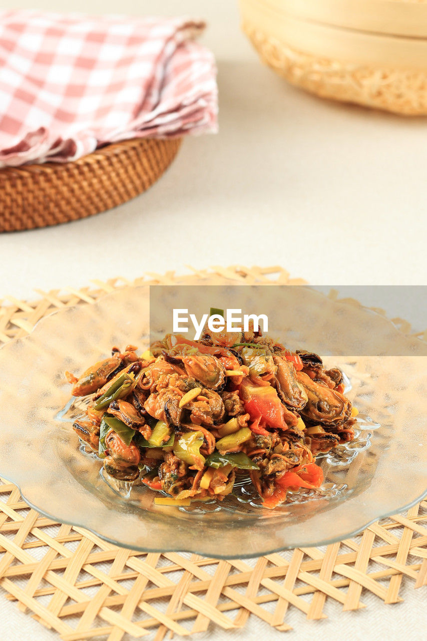 Stir fry oyster with chilli, garlic, red onion, and lime leaf. oseng kerang or tumis kerang