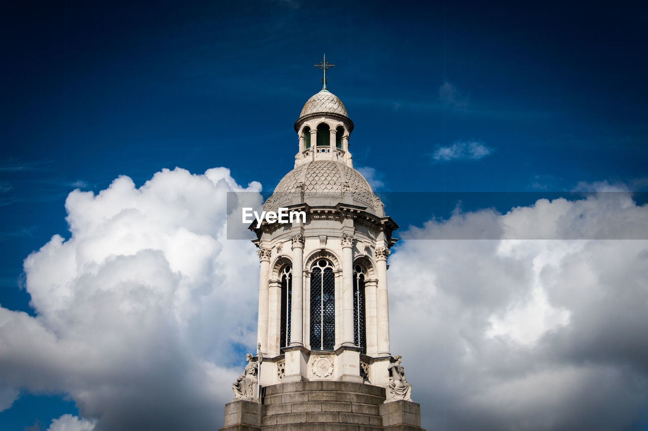 High section of cathedral against cloudy sky