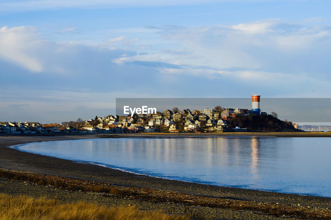 SEA AND BUILDINGS AGAINST SKY