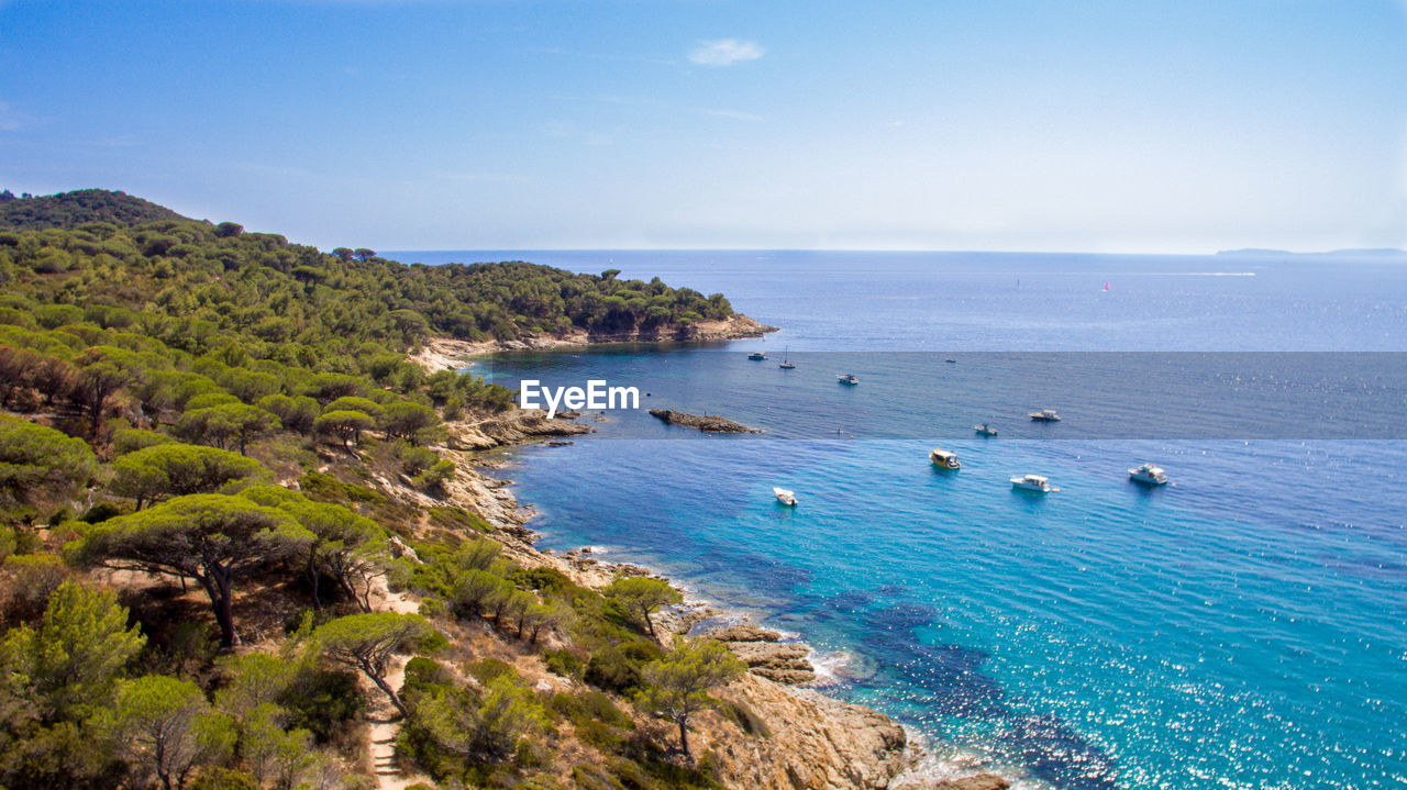 water, sea, land, scenics - nature, beach, sky, beauty in nature, nature, blue, coast, travel, travel destinations, body of water, ocean, coastline, nautical vessel, shore, tranquility, environment, horizon over water, landscape, cliff, tranquil scene, tourism, island, horizon, holiday, vacation, transportation, trip, seascape, no people, cove, tree, plant, idyllic, rock, bay, terrain, outdoors, islet, day, bay of water, summer, high angle view, non-urban scene, cloud, tropical climate, clear sky, sunny, mode of transportation, sunlight, lagoon, mountain, aerial view, sand
