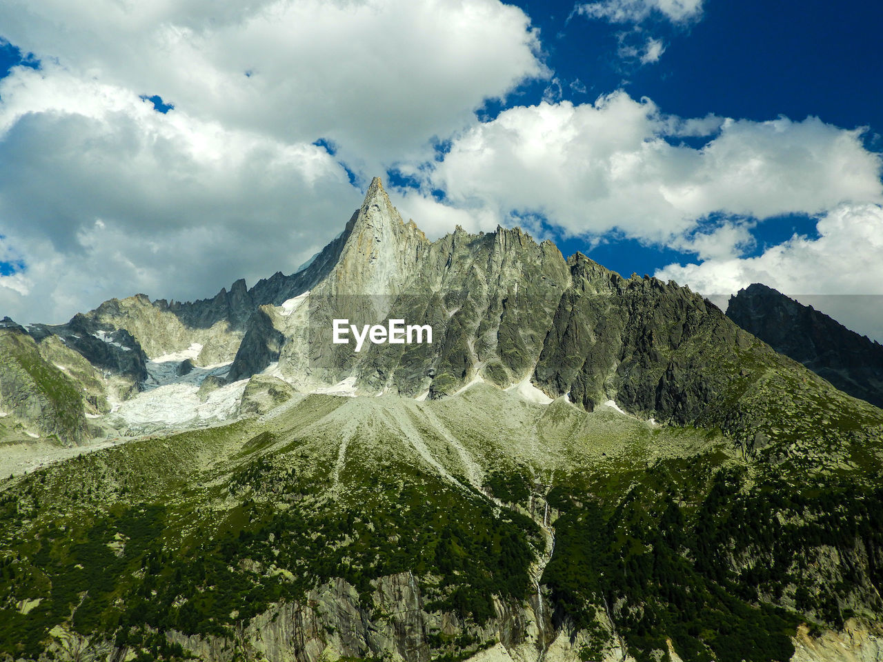 Low angle view of snowcapped mountains against sky