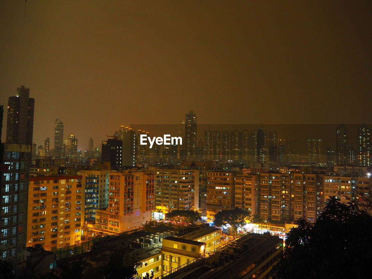 Illuminated cityscape against sky at night