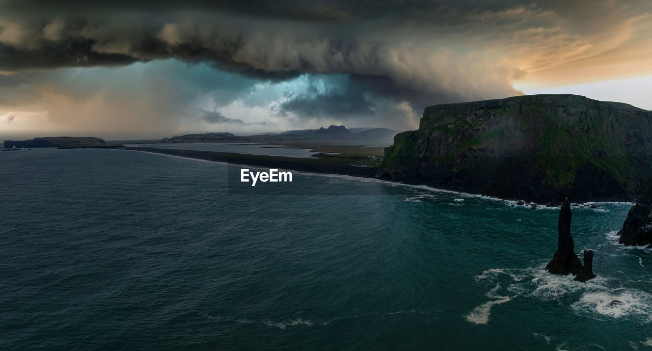 Iceland black sand beach with huge waves at reynisfjara vik.