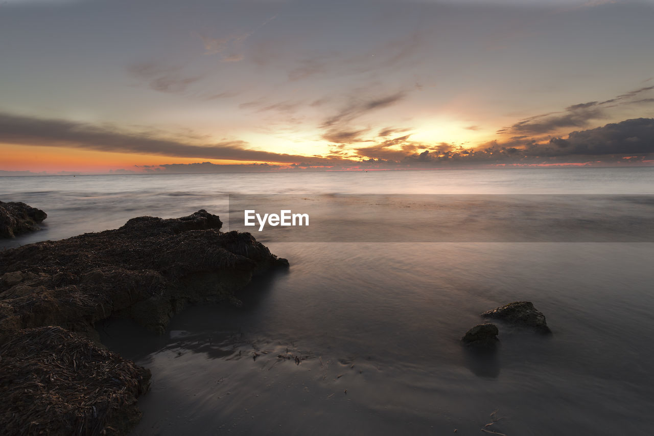 Scenic view of sea against sky during sunset