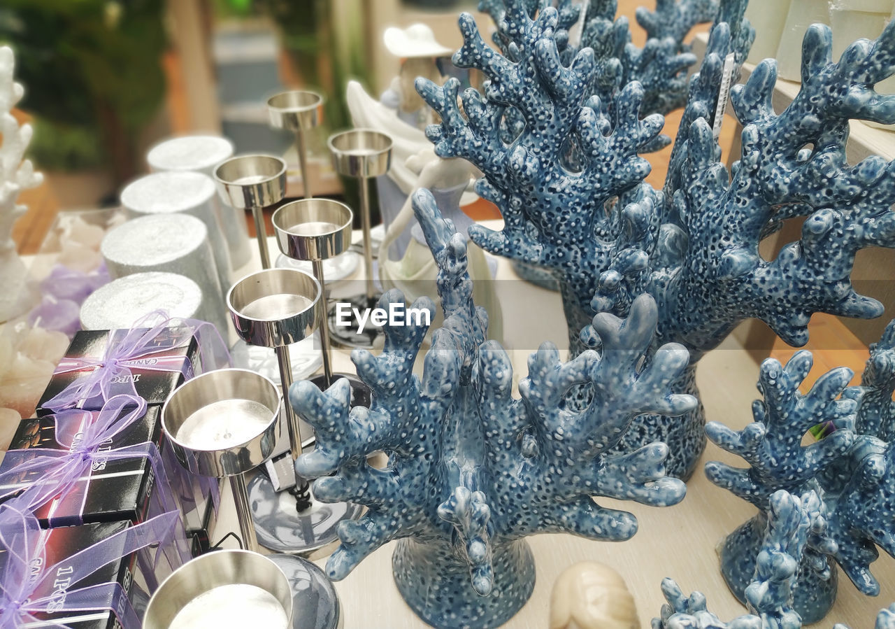 CLOSE-UP OF CHRISTMAS DECORATIONS ON TABLE IN ILLUMINATED CITY