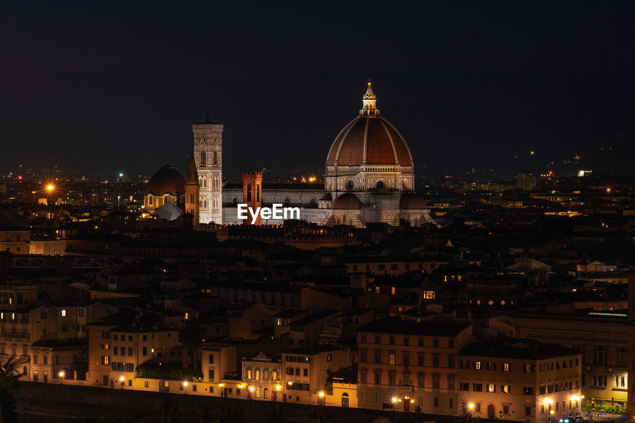 Illuminated buildings in city at night florence