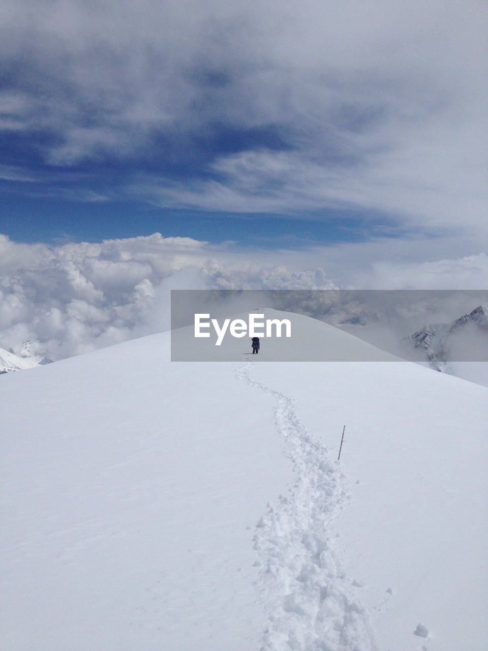 Rear view of a person walking on snow covered landscape