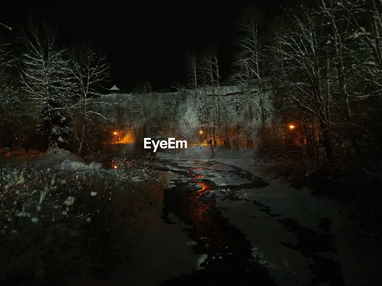 FROZEN RIVER AGAINST SKY AT NIGHT