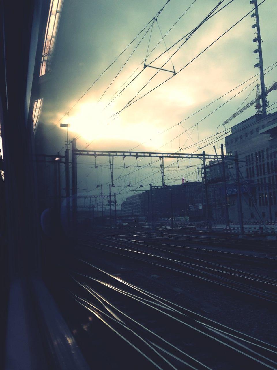 Railroad tracks and building seen through train window