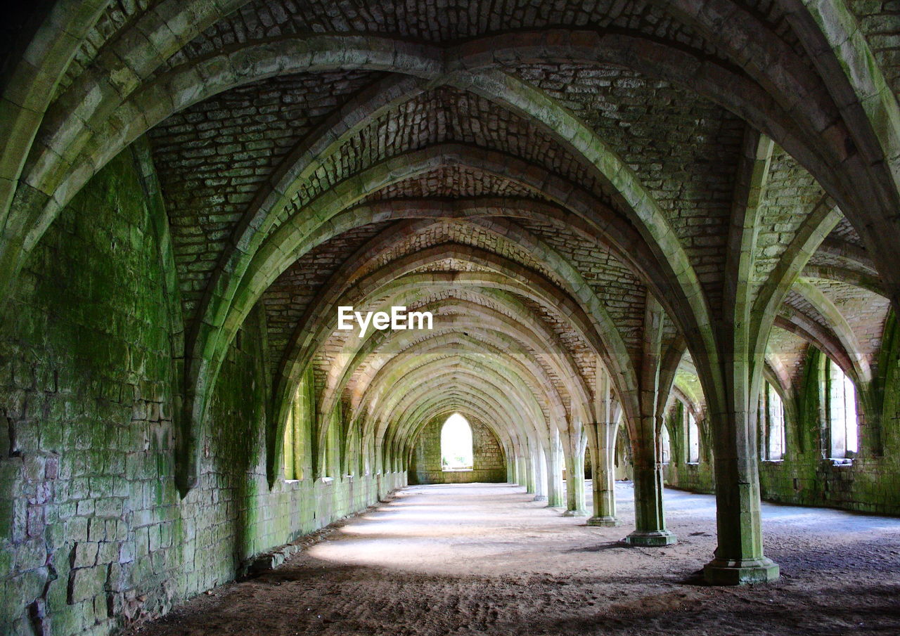 Empty corridor along arched ceiling