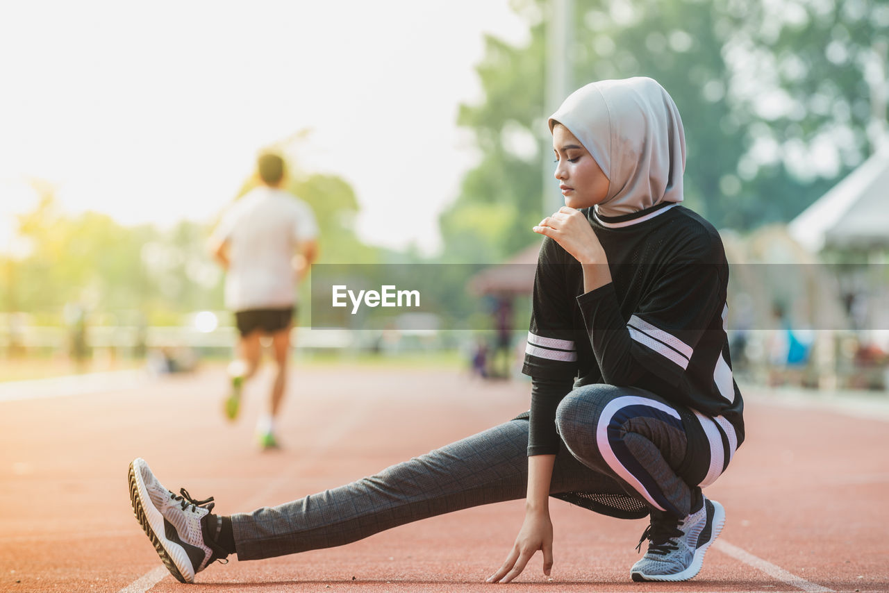 Female athlete exercising on track