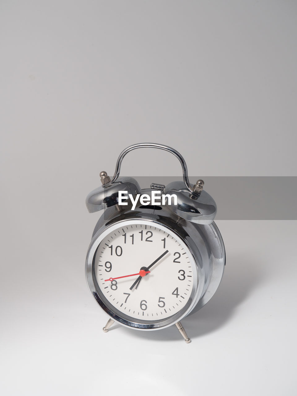 Close-up of alarm clock against gray background