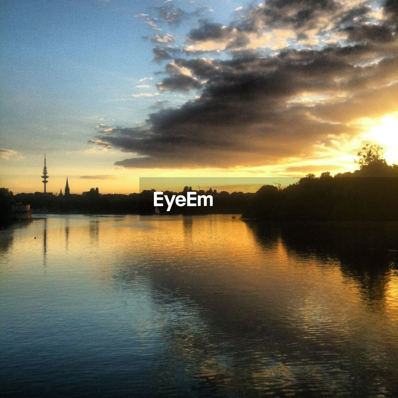 SCENIC VIEW OF CALM LAKE AT SUNSET