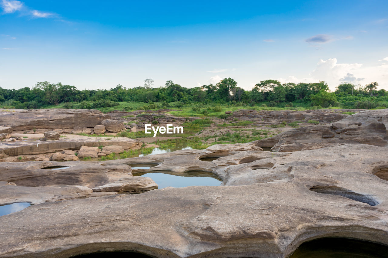 ROCKS ON LAND AGAINST SKY