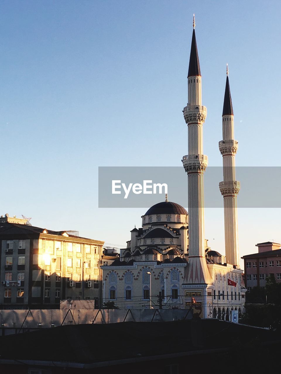 View of buildings in city against clear sky