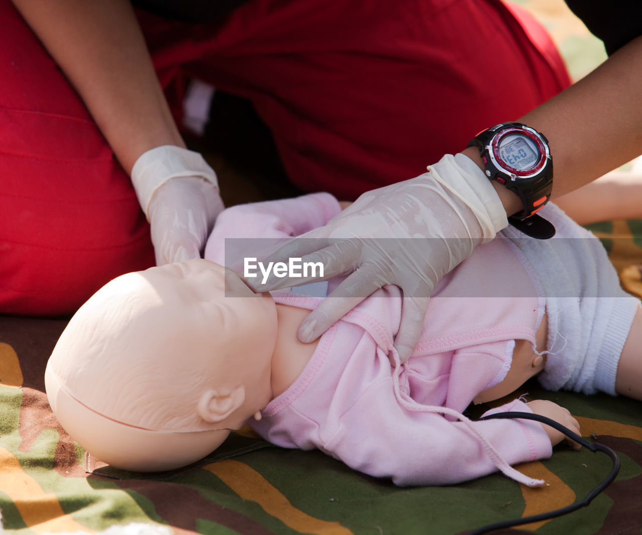 Midsection of woman learning cpr in fitness center