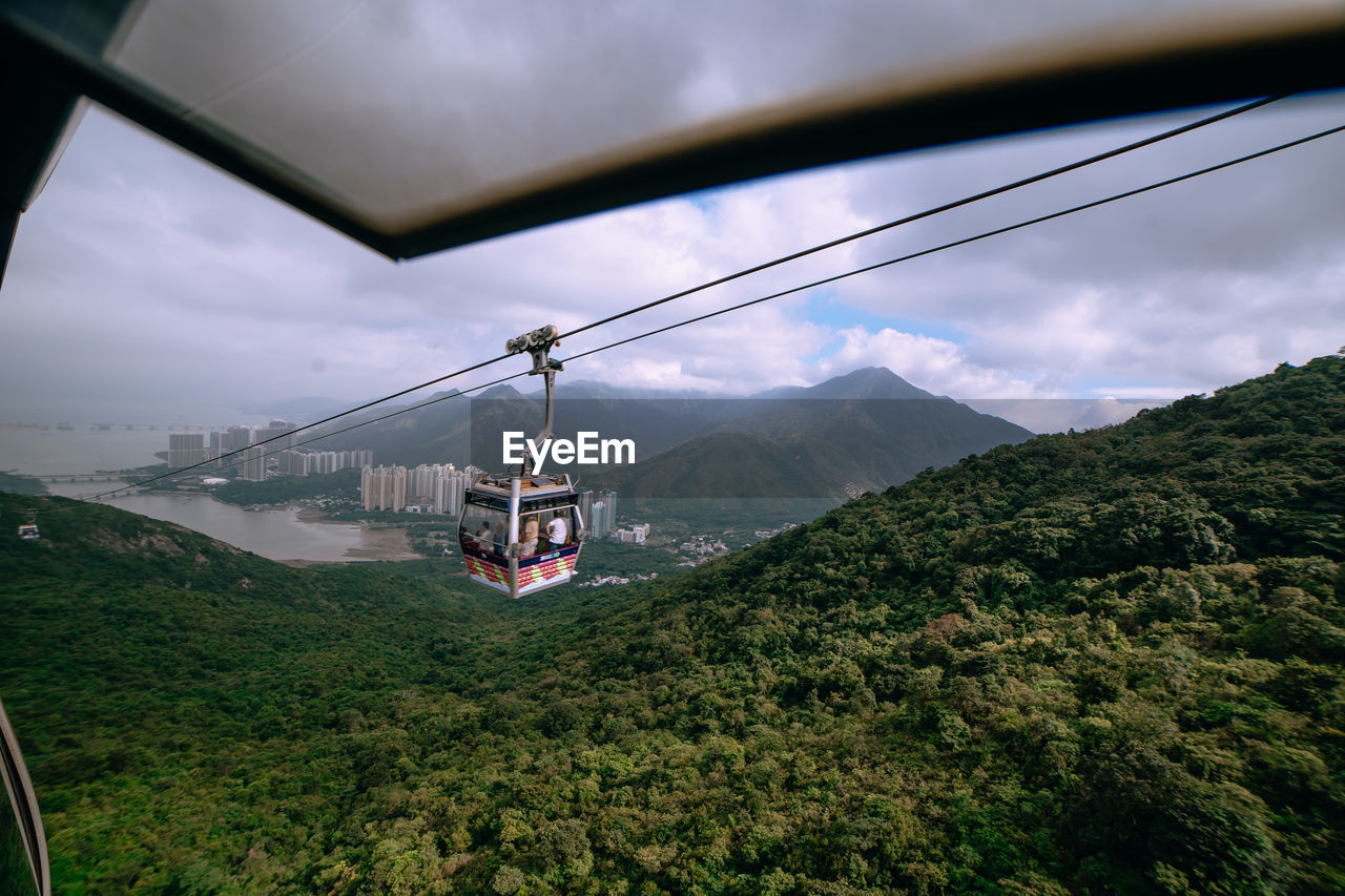 VIEW OF OVERHEAD CABLE CAR AGAINST CLOUDY SKY