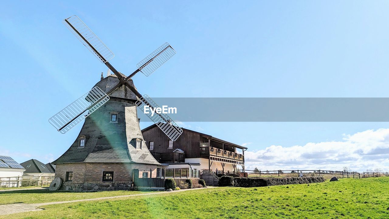 low angle view of windmill against sky