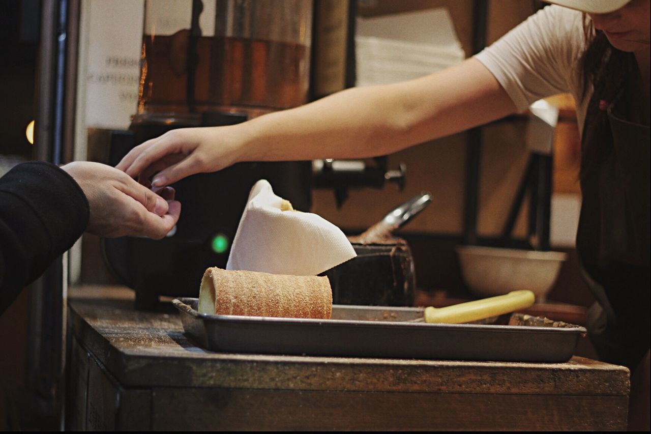 Midsection of woman selling food to customer