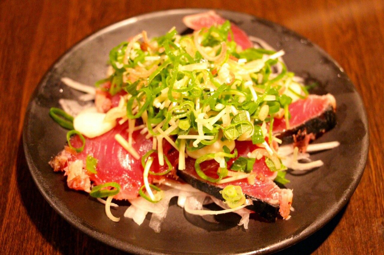 Close-up of sashimi served in plate on wooden table