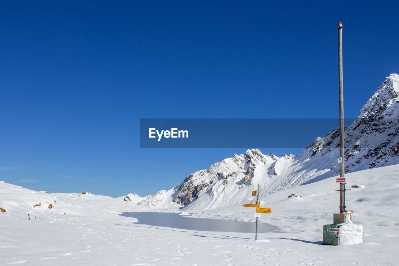 Snowcapped mountains against blue sky