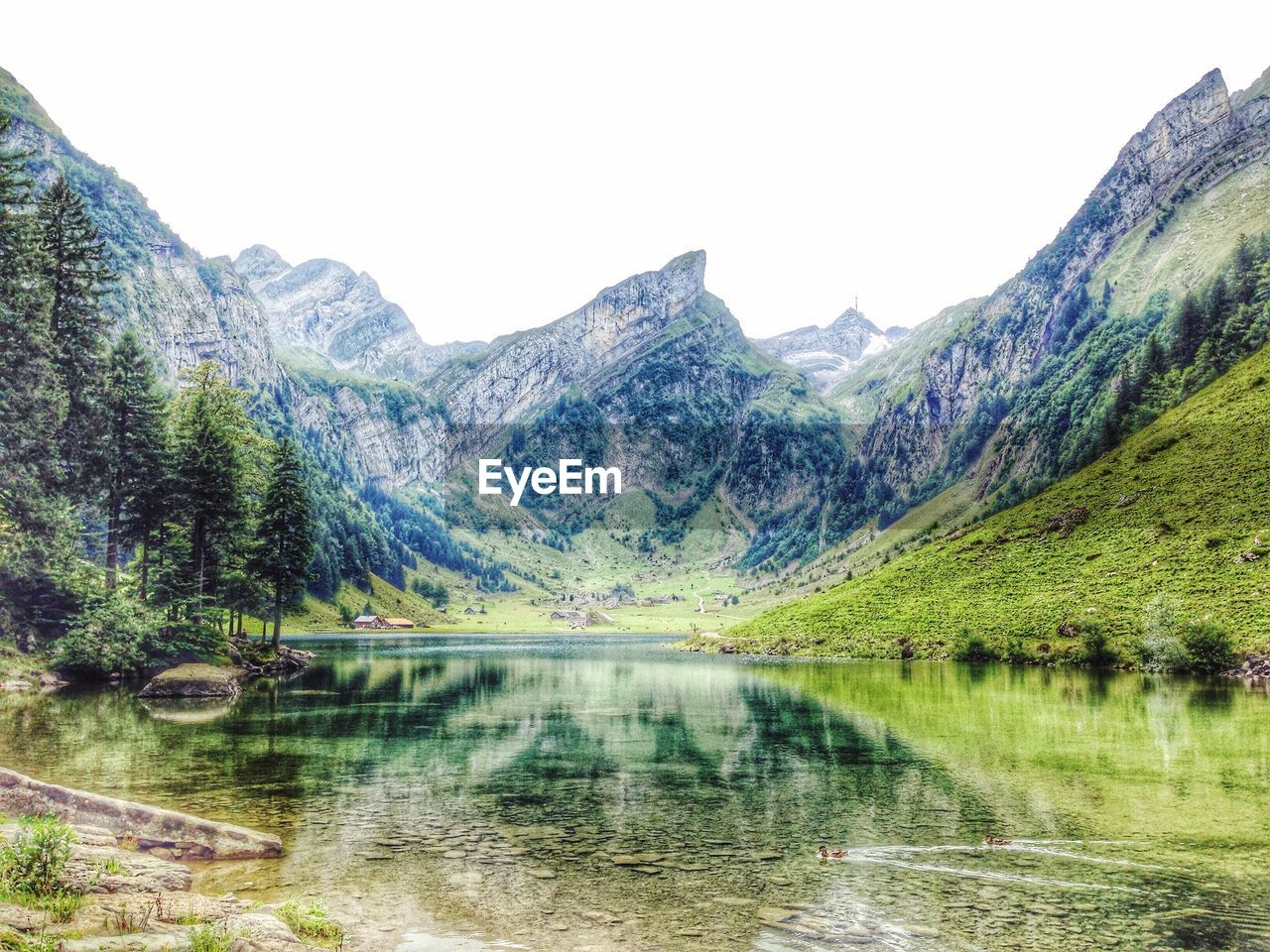 Scenic view of lake with mountain range in background