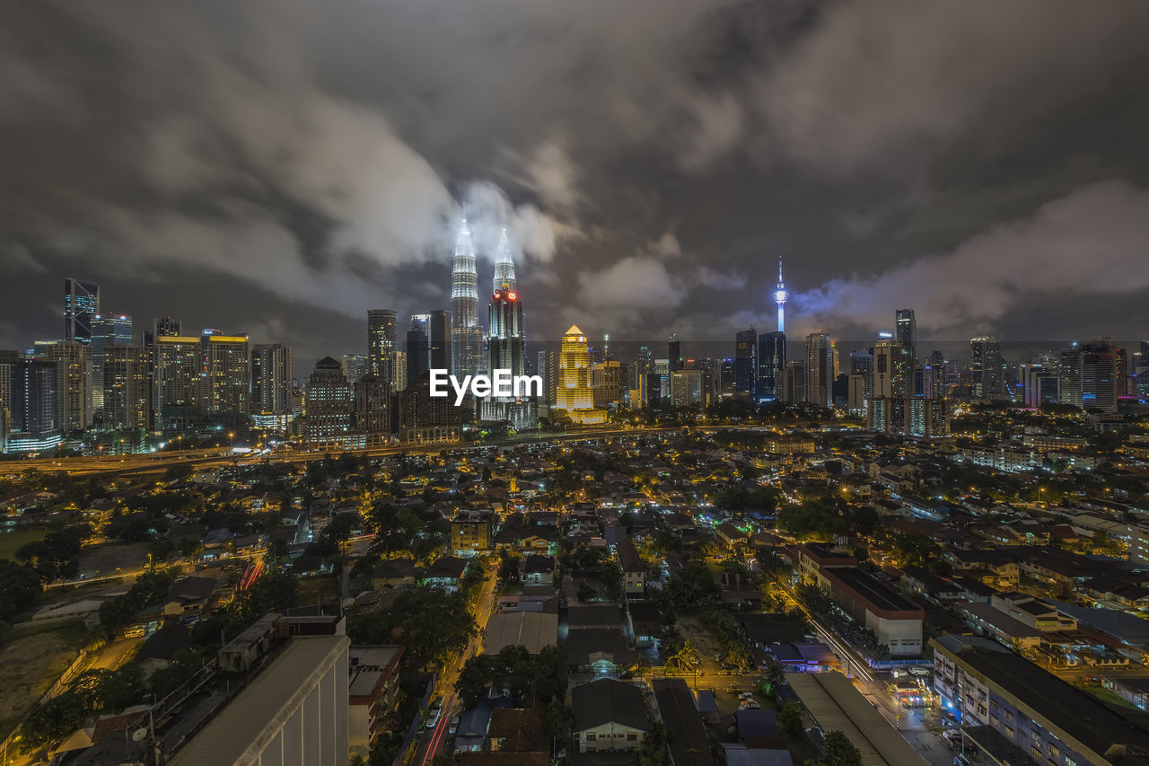 Distant view of petronas towers in illuminated city at night