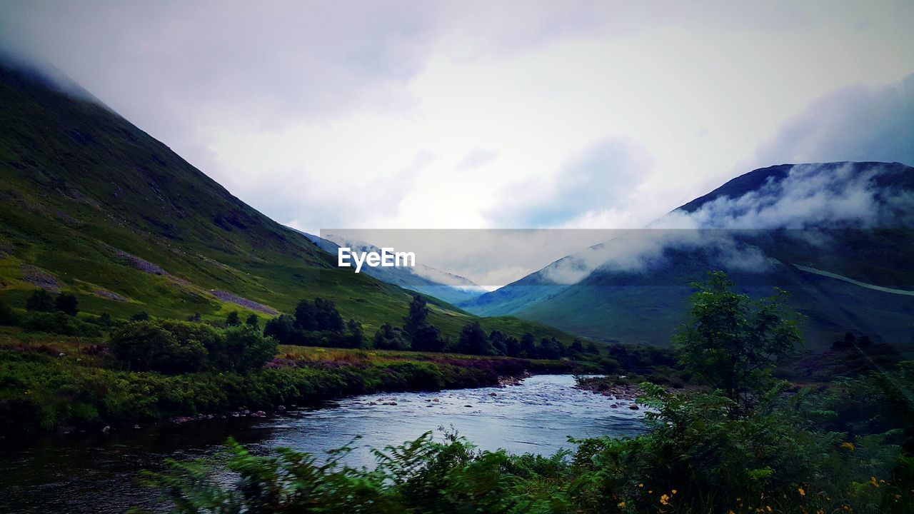 Scenic view of lake and mountains against sky