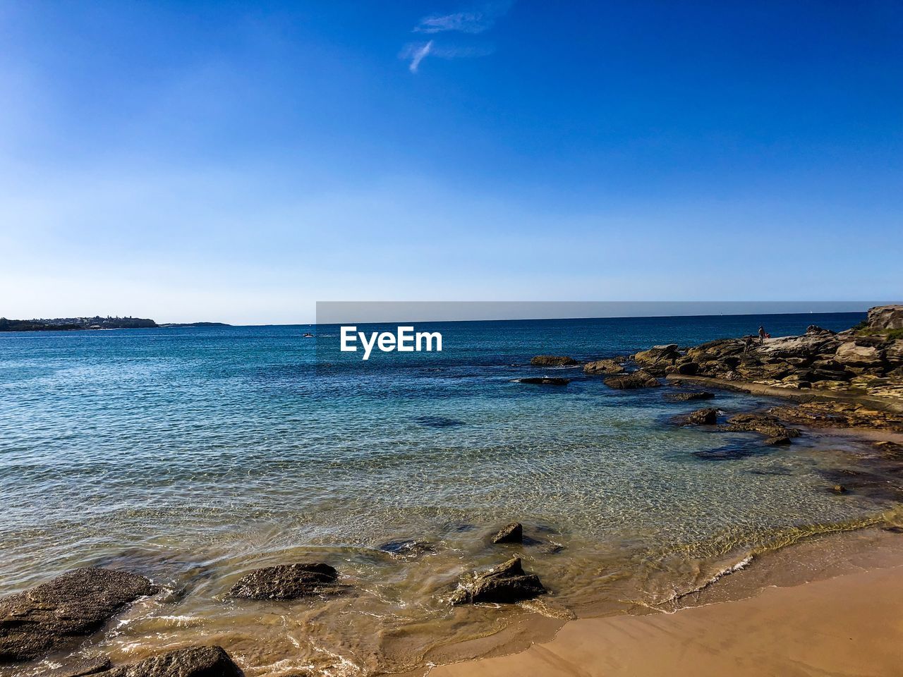 Scenic view of sea against clear blue sky